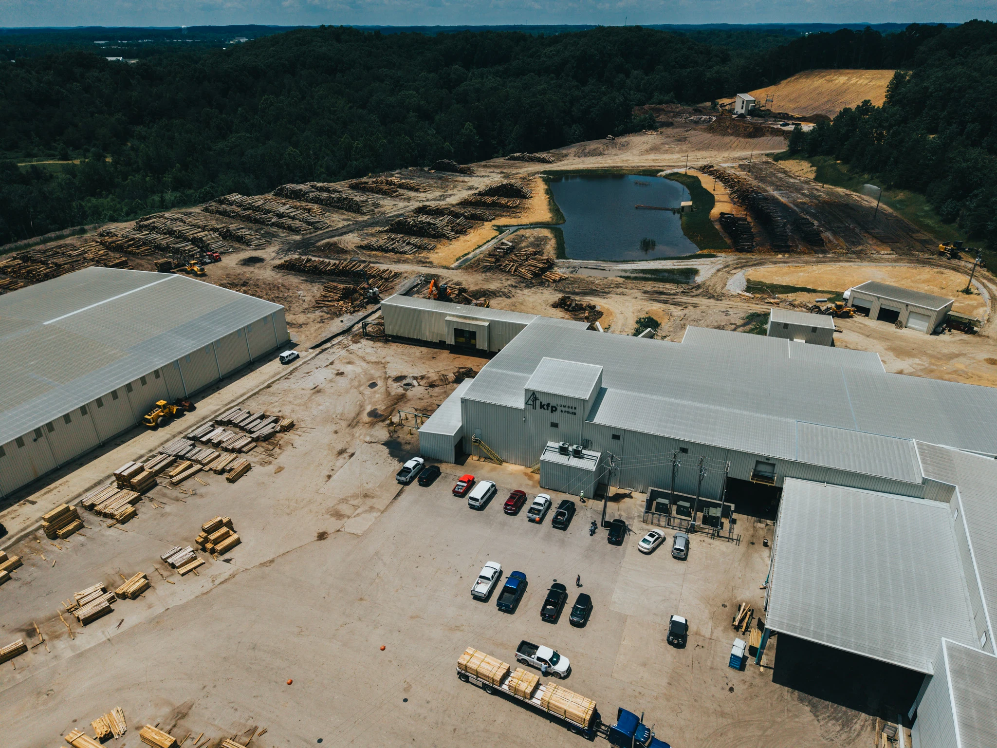 Aerial view of Kentucky Forest Products facility showing log yards and sawmill buildings