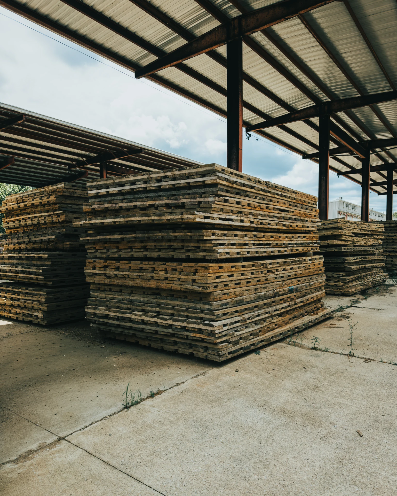Stacked timber matting under covered shed