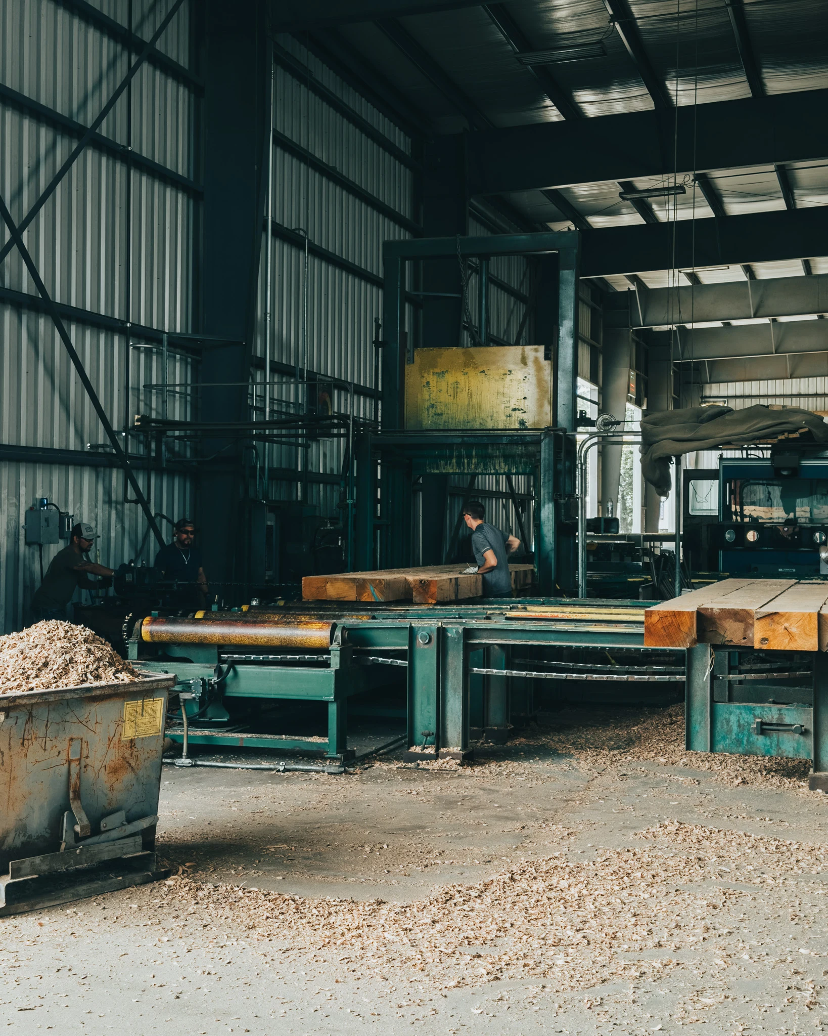 Workers operating the matting press on the production floor